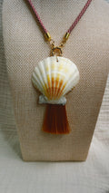 Cream scallop shell with rust silk tassel on burgundy cord