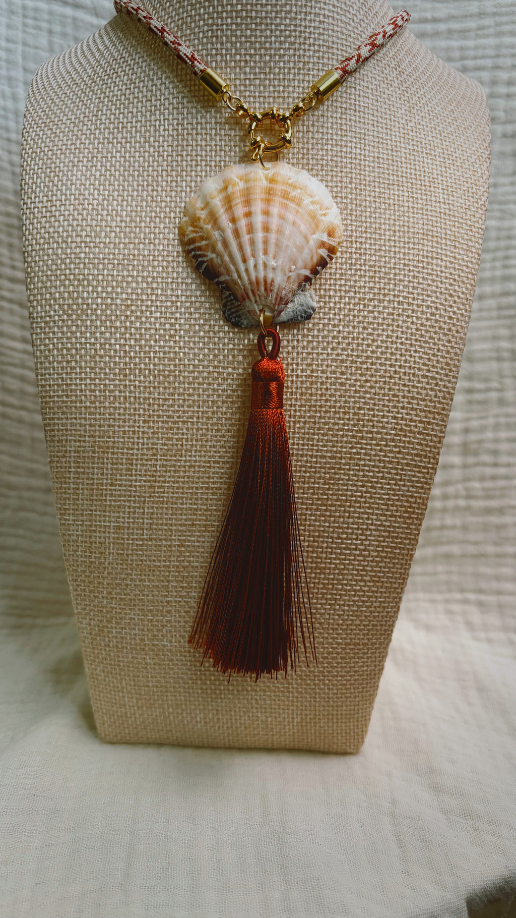 Cream scallop shell with soft burgundy tassel