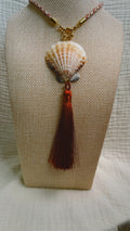 Cream scallop shell with soft burgundy tassel