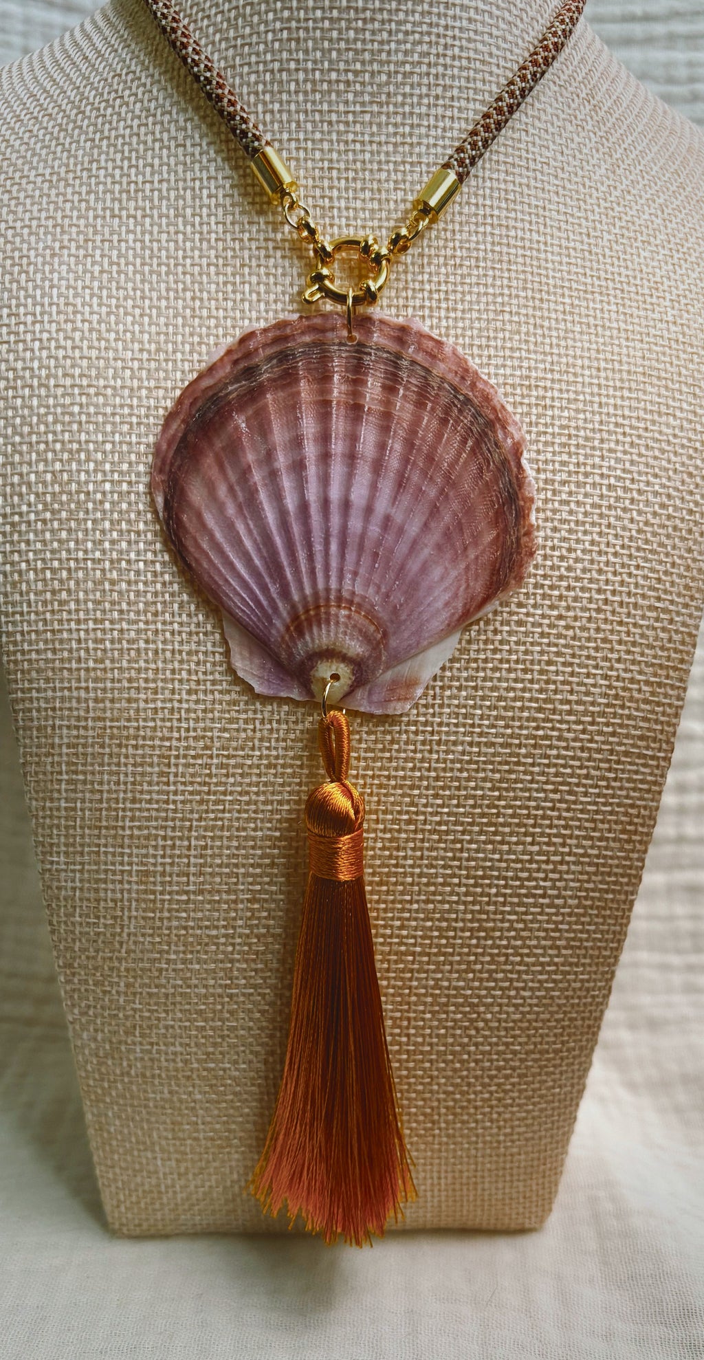 Mauve scallop shell necklace with copper silk tassel on patterned cord