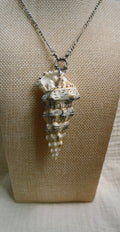 Cream spindle shell pendant on silver-tone metal chain