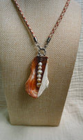 Copper oyster shell with pearls on peach patterned cord