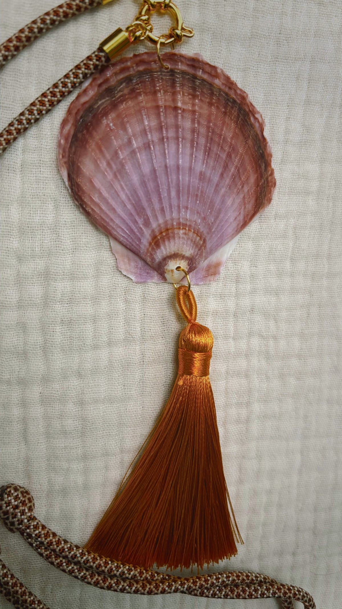 Mauve scallop shell necklace with copper silk tassel on patterned cord