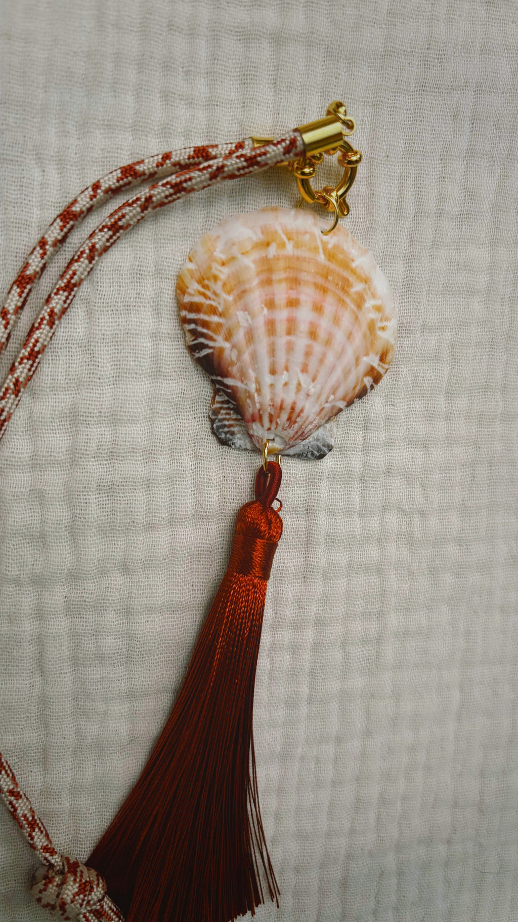 Scallop shell necklace with burgundy silk tassel on patterned cord