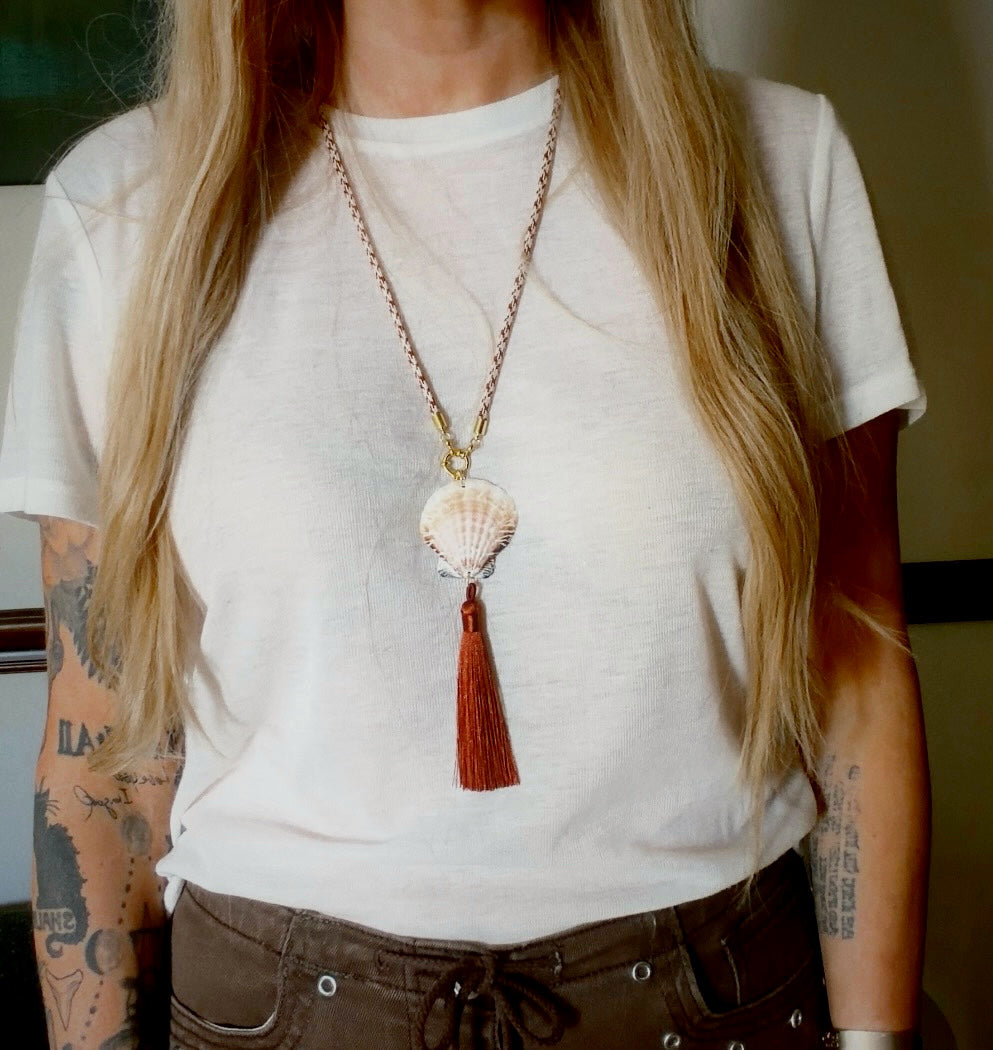 Cream scallop shell with rust silk tassel on burgundy cord