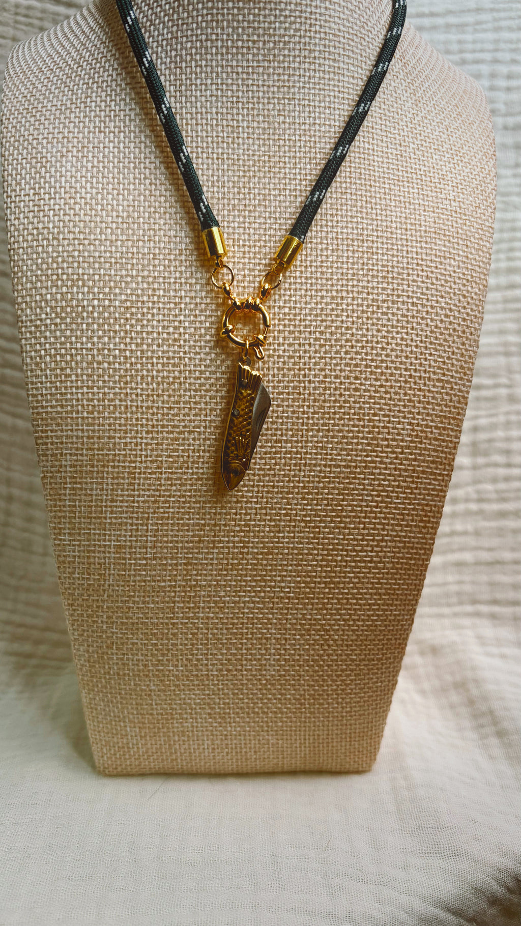 Dark shell fragment pendant on black patterned paracord